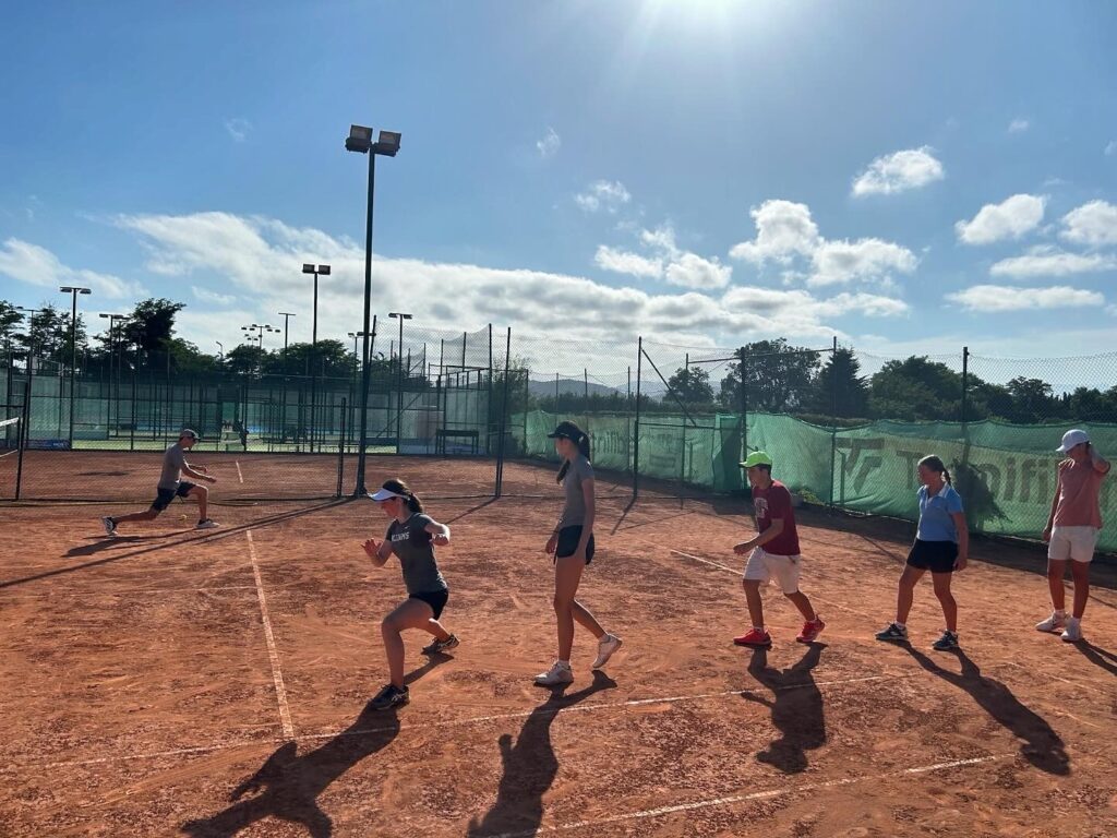 practicing sliding during atlas tennis first tennis practice in spain
