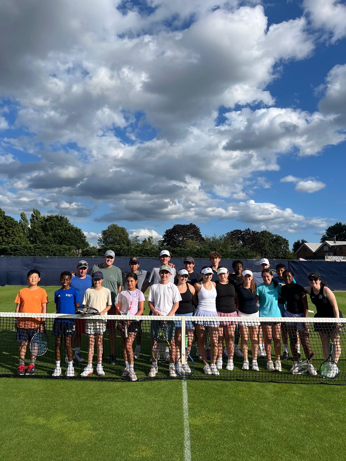 Atlas Tennis Bucket List Trip team on a grass court in London